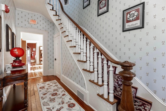 810 Lambton Cir W, Lancaster, OH 43130 - stairs with hardwood / wood-style flooring, wallpapered walls, and vaulted ceiling