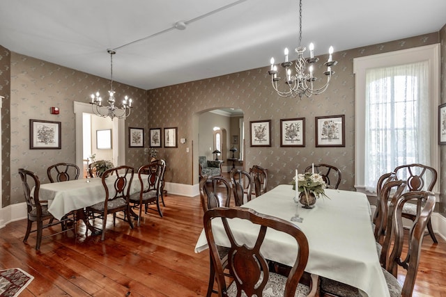 810 Lambton Cir W, Lancaster, OH 43130 - dining room featuring a chandelier, wallpapered walls, hardwood / wood-style floors, and arched walkways