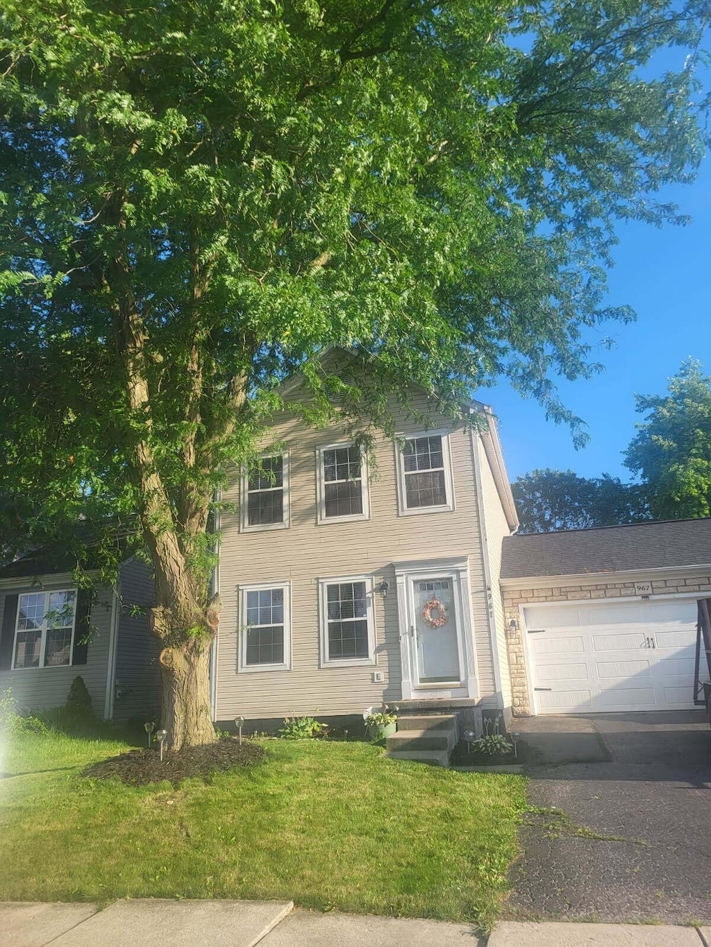 967 Robmeyer Dr, Columbus, OH 43207 - view of front facade featuring a front yard, driveway, and a garage