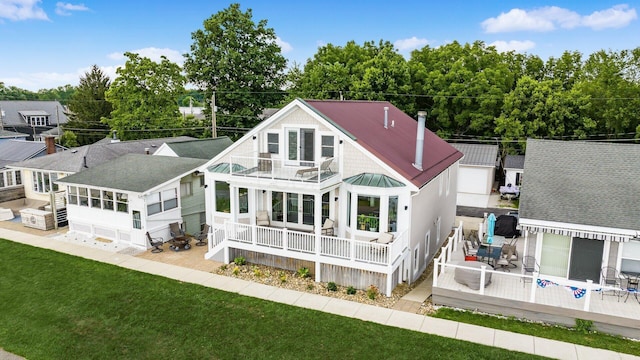 4721 W N Bank Rd, Buckeye Lake, OH 43008 - back of house featuring a balcony, a standing seam roof, a metal roof, and a yard