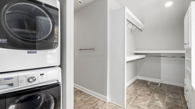 4721 W N Bank Rd, Buckeye Lake, OH 43008 - laundry room with stacked washer / drying machine and stone finish floors