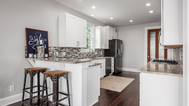 4721 W N Bank Rd, Buckeye Lake, OH 43008 - kitchen with recessed lighting, decorative backsplash, a breakfast bar area, stainless steel appliances, and light stone countertops