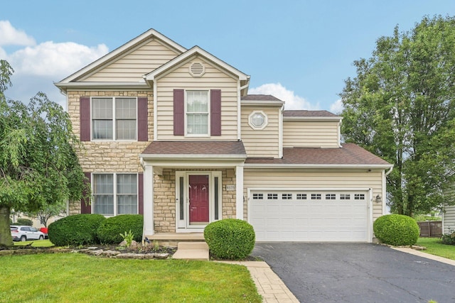 9375 Wingate Pl, Orient, OH 43146 - traditional-style house with stone siding, driveway, a front yard, and a shingled roof