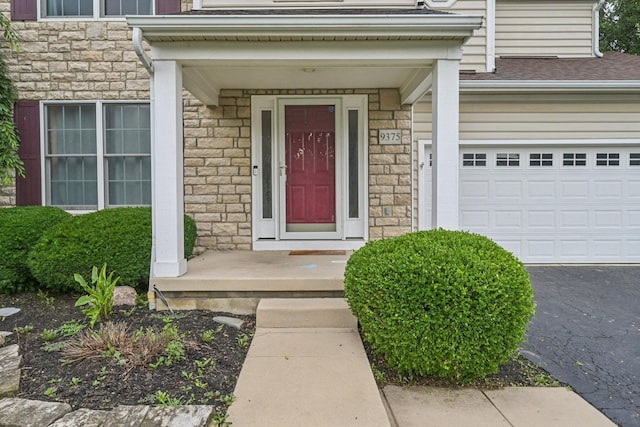 9375 Wingate Pl, Orient, OH 43146 - property entrance featuring stone siding, asphalt driveway, and roof with shingles
