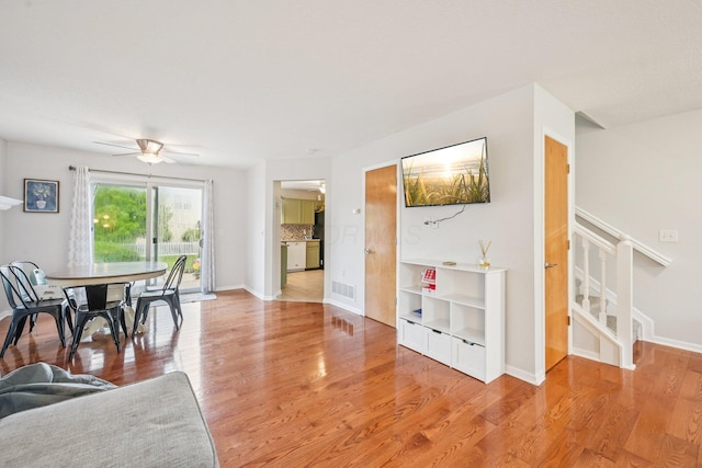 9375 Wingate Pl, Orient, OH 43146 - dining room with ceiling fan, light wood-type flooring, and stairs