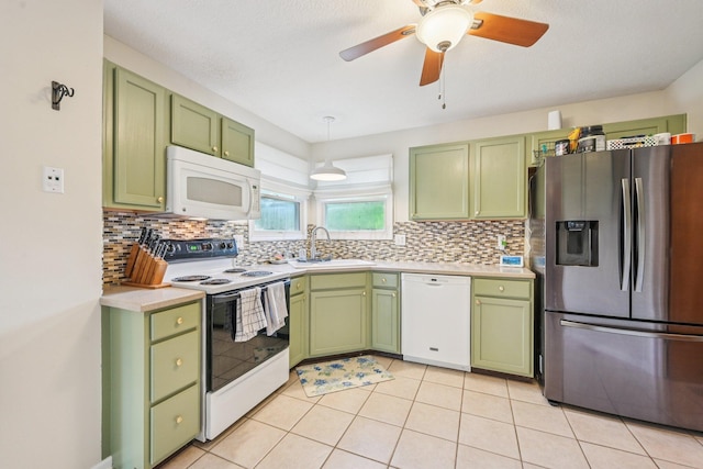 9375 Wingate Pl, Orient, OH 43146 - kitchen featuring green cabinetry, white appliances, light countertops, and backsplash
