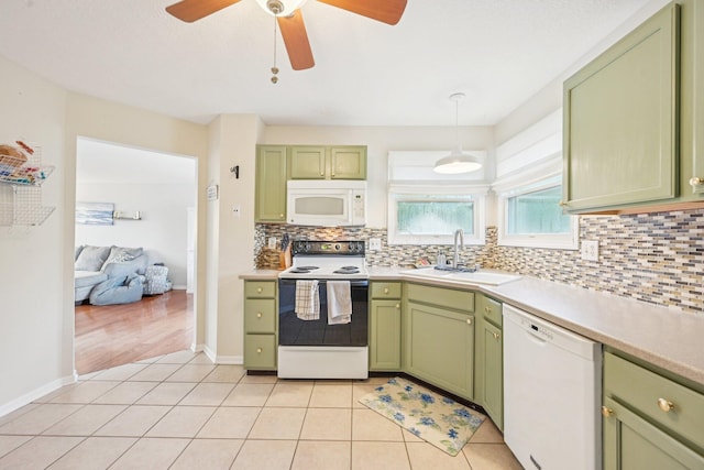 9375 Wingate Pl, Orient, OH 43146 - kitchen with green cabinetry, white appliances, tasteful backsplash, and light countertops