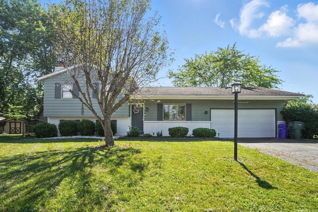 1978 Candlenut Cir, Grove City, OH 43123 - tri-level home featuring a garage, driveway, a front yard, and brick siding