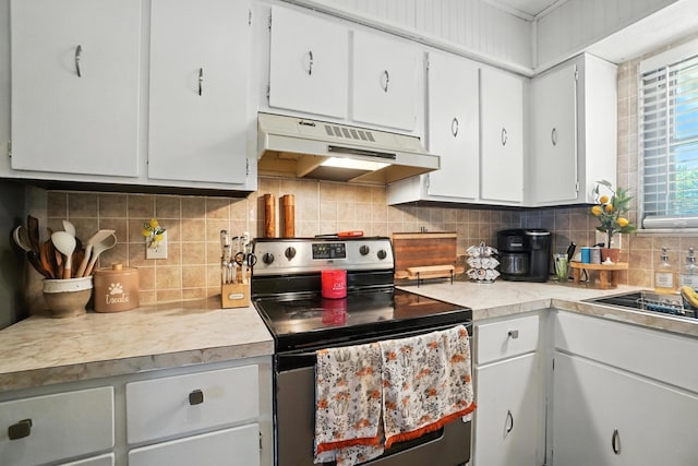 1978 Candlenut Cir, Grove City, OH 43123 - kitchen featuring stainless steel electric range oven, under cabinet range hood, light countertops, decorative backsplash, and white cabinetry
