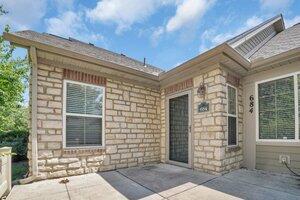 684 Old Dover Rd, Westerville, OH 43082 - view of exterior entry with a patio area, stone siding, and brick siding