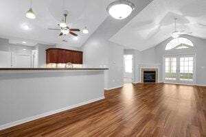 684 Old Dover Rd, Westerville, OH 43082 - unfurnished living room featuring a ceiling fan, lofted ceiling, wood finished floors, and a fireplace