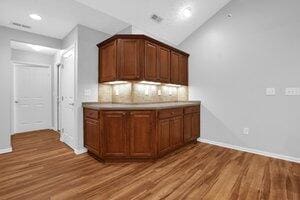 684 Old Dover Rd, Westerville, OH 43082 - kitchen featuring wood finished floors, backsplash, vaulted ceiling, light countertops, and recessed lighting