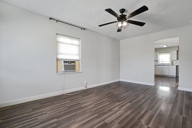 1458 E 22nd Ave, Columbus, OH 43211 - unfurnished room featuring cooling unit, dark wood-style floors, a ceiling fan, and a textured ceiling