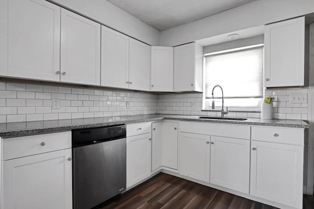 1458 E 22nd Ave, Columbus, OH 43211 - kitchen featuring stainless steel dishwasher, dark wood-style floors, white cabinets, backsplash, and dark stone countertops
