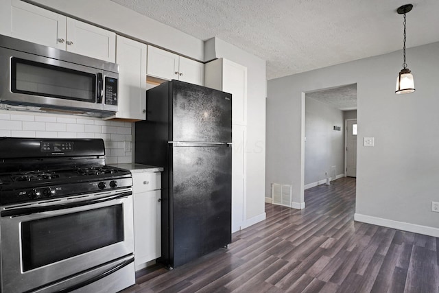 1458 E 22nd Ave, Columbus, OH 43211 - kitchen with stainless steel appliances, dark wood finished floors, white cabinets, backsplash, and a textured ceiling