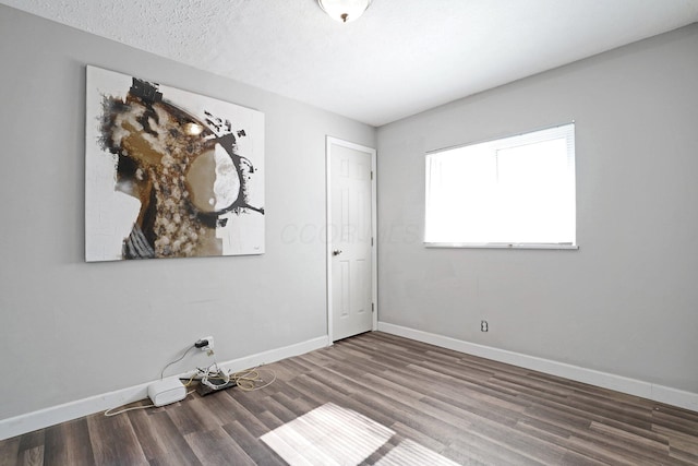 1458 E 22nd Ave, Columbus, OH 43211 - unfurnished room featuring wood finished floors and a textured ceiling