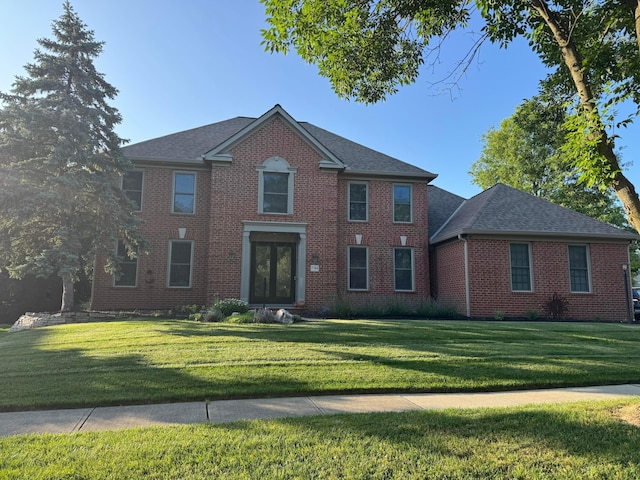 7744 Heatherwood Ln, Dublin, OH 43017 - view of front of house with brick siding, a front yard, and roof with shingles