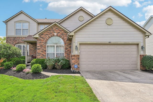 1077 Taylor Mills Dr, Reynoldsburg, OH 43068 - view of front of property featuring brick siding, a garage, and driveway
