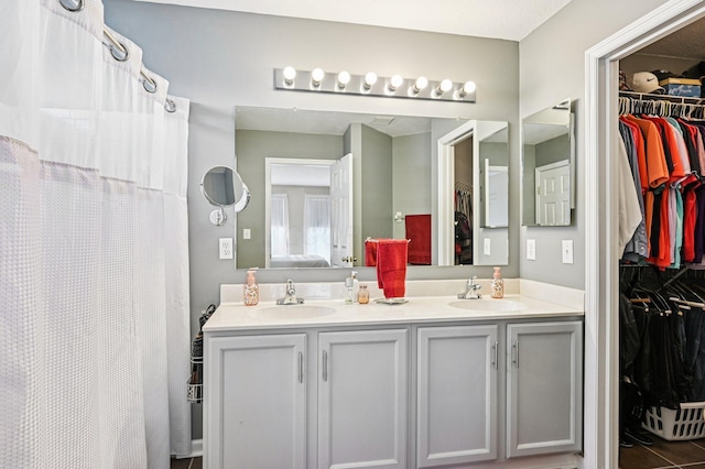 1077 Taylor Mills Dr, Reynoldsburg, OH 43068 - bathroom featuring double vanity and a walk in closet