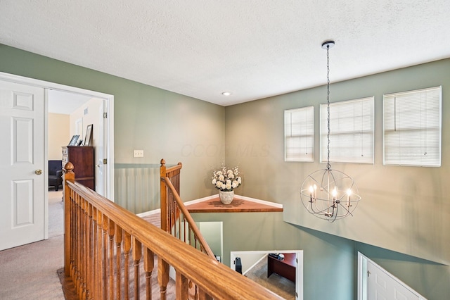 1077 Taylor Mills Dr, Reynoldsburg, OH 43068 - hall featuring an upstairs landing, carpet flooring, a chandelier, and a textured ceiling