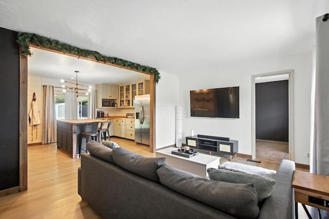 3139 Woonsocket St, Springfield, OH 45503 - living room featuring light wood finished floors and a chandelier