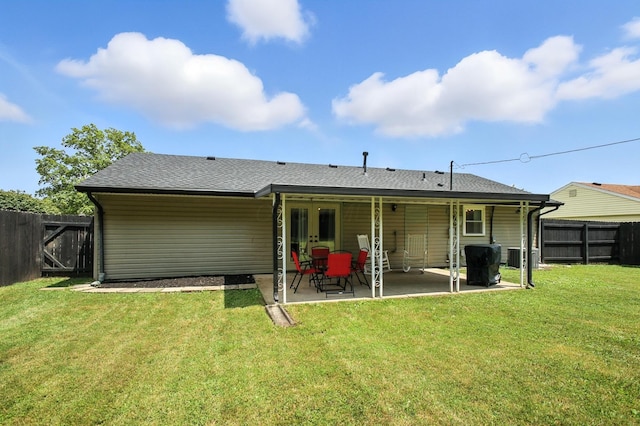 3139 Woonsocket St, Springfield, OH 45503 - back of property featuring roof with shingles, a fenced backyard, and a patio
