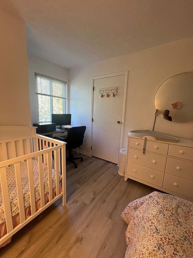 5258 Captains Ct, Columbus, OH 43220 - bedroom with wood finished floors, a desk, and a textured ceiling
