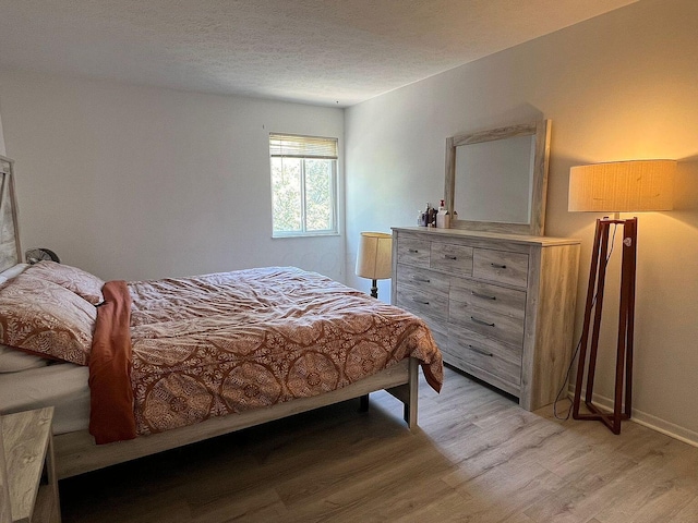 5258 Captains Ct, Columbus, OH 43220 - bedroom with light wood-type flooring and a textured ceiling