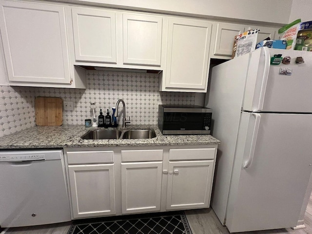 5258 Captains Ct, Columbus, OH 43220 - kitchen featuring freestanding refrigerator, dishwashing machine, light stone countertops, backsplash, and white cabinetry