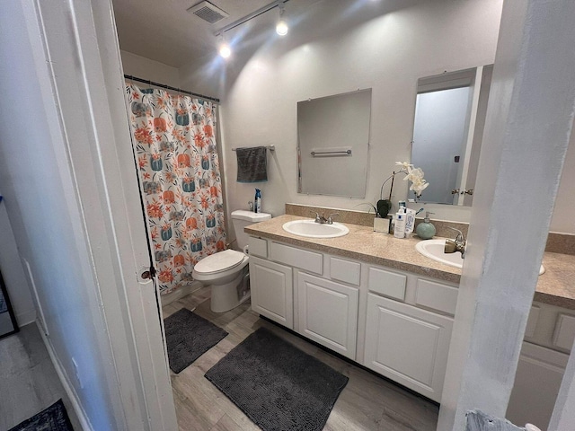 5258 Captains Ct, Columbus, OH 43220 - bathroom featuring double vanity, wood finished floors, track lighting, and curtained shower