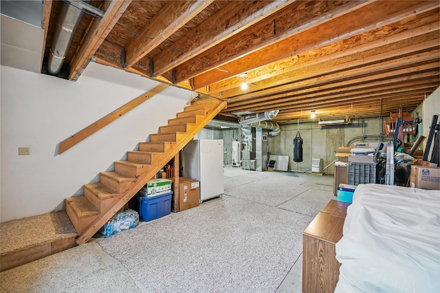 2532 State Route 292, West Mansfield, OH 43358 - unfinished below grade area with freestanding refrigerator, stairs, and gas water heater