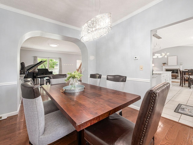 824 Lynnfield Dr, Westerville, OH 43081 - dining space with a chandelier, arched walkways, ornamental molding, and light wood finished floors