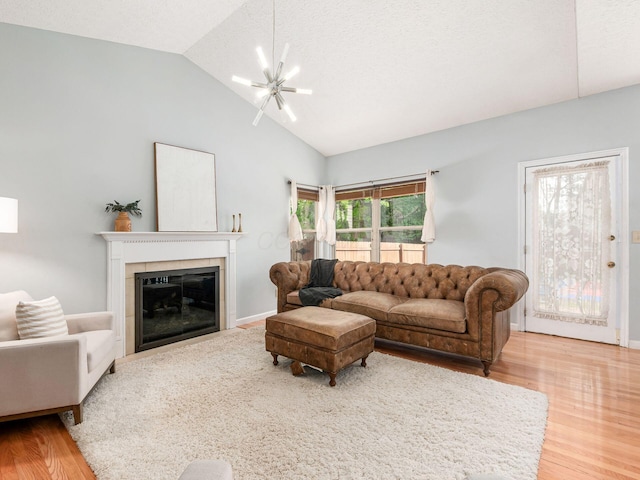824 Lynnfield Dr, Westerville, OH 43081 - living room featuring lofted ceiling, wood finished floors, and a glass covered fireplace