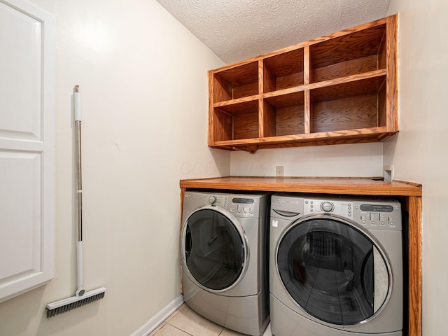 824 Lynnfield Dr, Westerville, OH 43081 - laundry room featuring independent washer and dryer, light tile patterned floors, and a textured ceiling