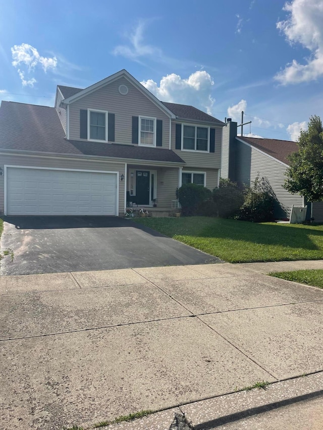 1889 Salt Lick Dr, Lancaster, OH 43130 - view of front of home featuring asphalt driveway, a front lawn, and an attached garage