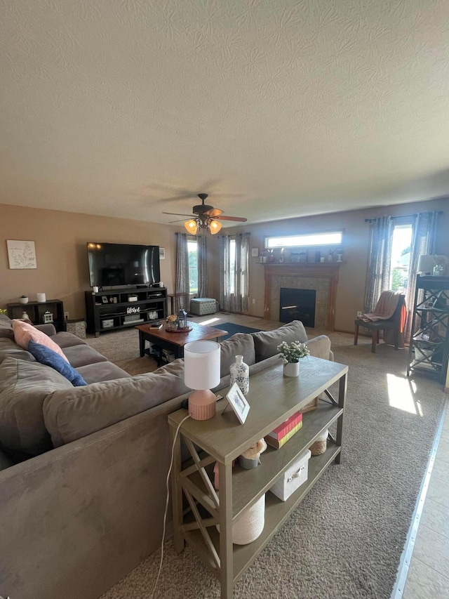 1889 Salt Lick Dr, Lancaster, OH 43130 - carpeted living room with a textured ceiling, a fireplace with raised hearth, and a ceiling fan