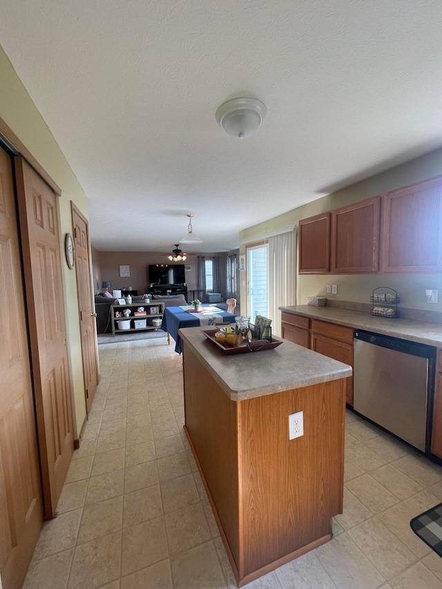 1889 Salt Lick Dr, Lancaster, OH 43130 - kitchen featuring stainless steel dishwasher, a center island, brown cabinets, open floor plan, and light countertops