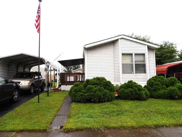 2445 Columbus Lancaster Rd NW Lot 463, Lancaster, OH 43130 - view of home's exterior featuring a carport, a yard, and a deck