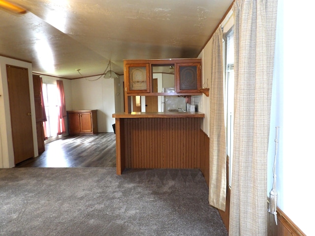 2445 Columbus Lancaster Rd NW Lot 463, Lancaster, OH 43130 - kitchen featuring dark colored carpet, a peninsula, and brown cabinets