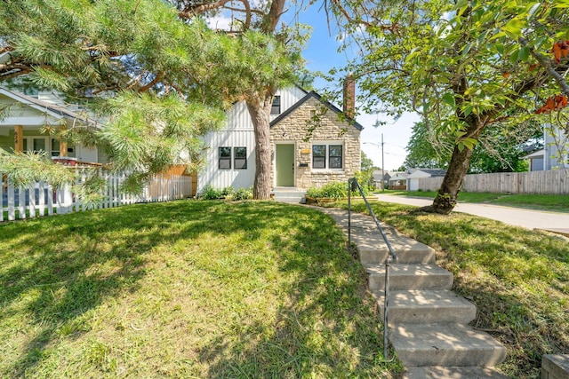 628 E Gates St, Columbus, OH 43206 - view of front of home with stone siding, a chimney, and board and batten siding