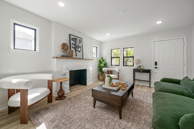 628 E Gates St, Columbus, OH 43206 - living room featuring light wood-style floors, a fireplace, and recessed lighting