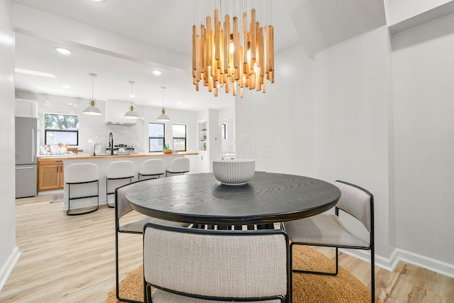 628 E Gates St, Columbus, OH 43206 - dining room with light wood-type flooring, recessed lighting, a chandelier, and healthy amount of natural light