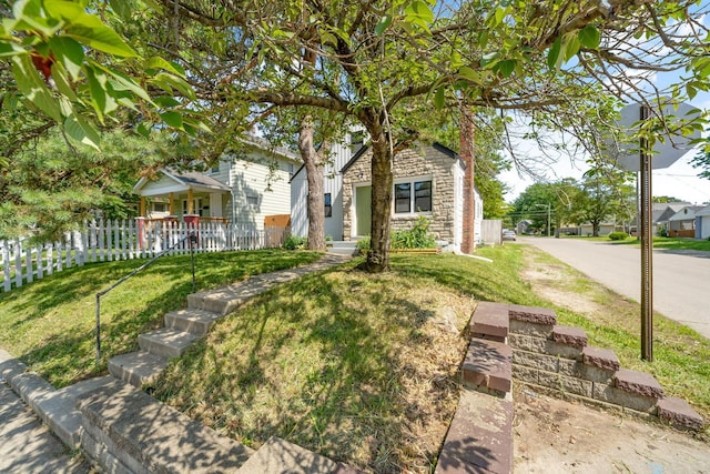 628 E Gates St, Columbus, OH 43206 - view of property hidden behind natural elements with stone siding and covered porch