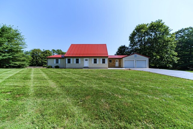 368 Woodview Dr, Chillicothe, OH 45601 - view of front of home featuring driveway, a front lawn, an attached garage, and a metal roof