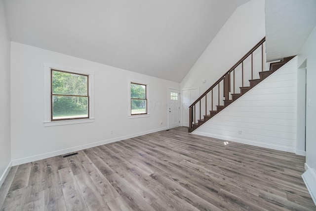 368 Woodview Dr, Chillicothe, OH 45601 - unfurnished living room featuring wood finished floors, stairs, and high vaulted ceiling
