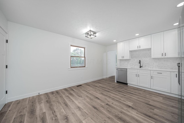 368 Woodview Dr, Chillicothe, OH 45601 - kitchen featuring stainless steel dishwasher, light countertops, recessed lighting, decorative backsplash, and white cabinetry