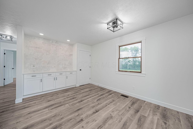 368 Woodview Dr, Chillicothe, OH 45601 - empty room with light wood finished floors, a textured ceiling, and recessed lighting