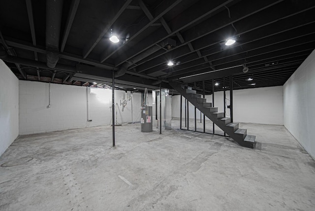 368 Woodview Dr, Chillicothe, OH 45601 - unfinished basement featuring water heater, stairs, and concrete block wall