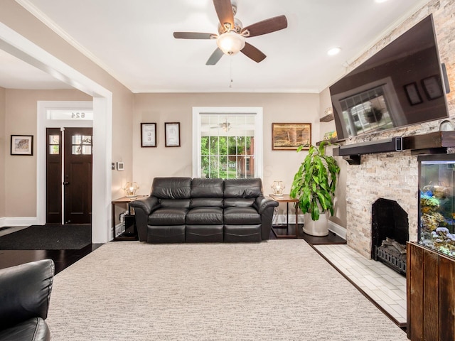 624 Oakwood Ave, Columbus, OH 43205 - living room with ceiling fan, ornamental molding, and a stone fireplace