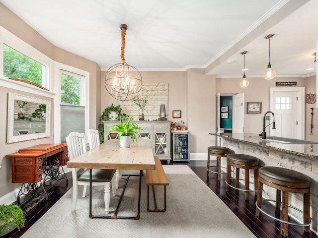 624 Oakwood Ave, Columbus, OH 43205 - dining area with dark wood-type flooring, a chandelier, and ornamental molding